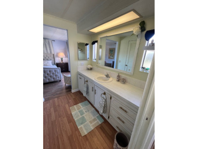 This charming two-bedroom, two-bath home is located in the gated on Lake Fairways Country Club in Florida - for sale on GolfHomes.com, golf home, golf lot