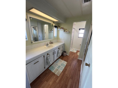 This charming two-bedroom, two-bath home is located in the gated on Lake Fairways Country Club in Florida - for sale on GolfHomes.com, golf home, golf lot