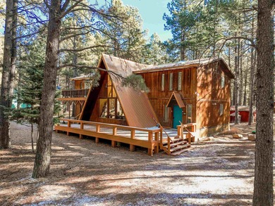 Welcome to 50 Knollwood Way, a quintessential A-frame chalet on Angel Fire Resort Country Club in New Mexico - for sale on GolfHomes.com, golf home, golf lot