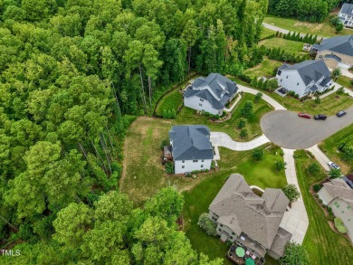 Behind the gates of Hasentree Country Golf Club community on Hasentree Club in North Carolina - for sale on GolfHomes.com, golf home, golf lot