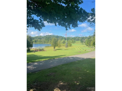 Discover the charm of this cozy tiny log home nestled in the on Cedar Lake Club in New York - for sale on GolfHomes.com, golf home, golf lot