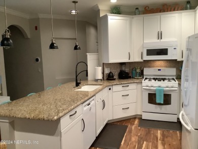 Elegantly updated and remodeled 1st story end unit with private on Windsor Parke Golf Club in Florida - for sale on GolfHomes.com, golf home, golf lot