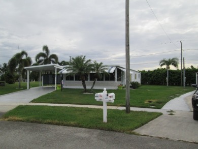 HUGE CORNER LOT PROPERTY WITH A PRIVATE DOCK & WITH A BEAUTIFUL on Cypress Creek Country Club - Boynton Beach in Florida - for sale on GolfHomes.com, golf home, golf lot