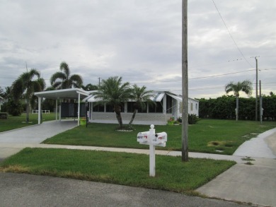 HUGE CORNER LOT PROPERTY WITH A PRIVATE DOCK & WITH A BEAUTIFUL on Cypress Creek Country Club - Boynton Beach in Florida - for sale on GolfHomes.com, golf home, golf lot