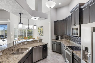 Set amidst private preserve and golf views, this better-than-new on Royal Tee Country Club in Florida - for sale on GolfHomes.com, golf home, golf lot