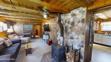 This charming cottage with approx 250 feet of direct water front on Bend Of The River Golf Course in New York - for sale on GolfHomes.com, golf home, golf lot