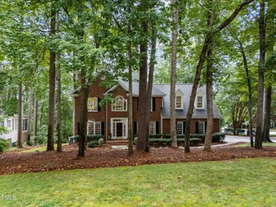 Nestled on a desirable corner lot, surrounded by mature trees in on Devils Ridge Golf Club in North Carolina - for sale on GolfHomes.com, golf home, golf lot