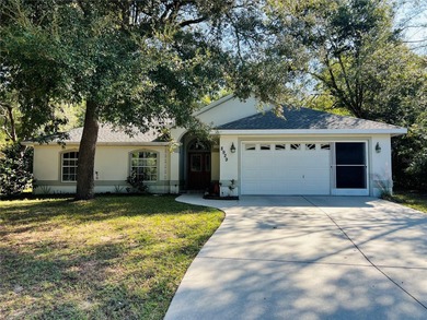 Charming three-bedroom, two-bathroom home featuring a two-car on Citrus Springs Country Club in Florida - for sale on GolfHomes.com, golf home, golf lot