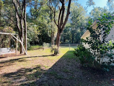 Charming three-bedroom, two-bathroom home featuring a two-car on Citrus Springs Country Club in Florida - for sale on GolfHomes.com, golf home, golf lot