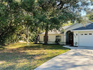 Charming three-bedroom, two-bathroom home featuring a two-car on Citrus Springs Country Club in Florida - for sale on GolfHomes.com, golf home, golf lot