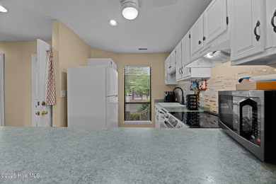 Live lakeside with water views from the kitchen, living area on Harbour Point Golf Club in North Carolina - for sale on GolfHomes.com, golf home, golf lot