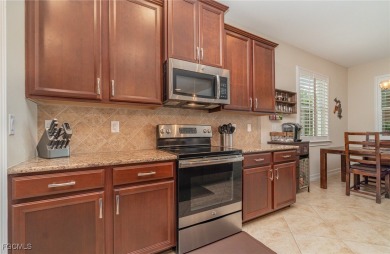 Stunning Golf & Lake Views | Oversized Saltwater Pool | on Herons Glen Golf and Country Club in Florida - for sale on GolfHomes.com, golf home, golf lot