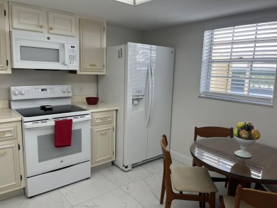 Very desirable bottom floor condo with views of the water, golf on Atlantis Golf Club in Florida - for sale on GolfHomes.com, golf home, golf lot
