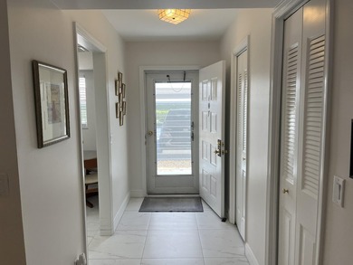 Very desirable bottom floor condo with views of the water, golf on Atlantis Golf Club in Florida - for sale on GolfHomes.com, golf home, golf lot