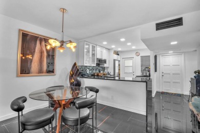 Wake up to sparkling lake views in this bright 1BR/1.5BA Palm on Palm-Aire Country Club and Resort - The Oaks in Florida - for sale on GolfHomes.com, golf home, golf lot