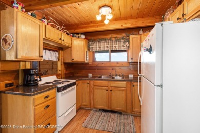 This charming Cedar log cabin is located on a scenic corner lot on Star Valley RV Golf Course in Wyoming - for sale on GolfHomes.com, golf home, golf lot