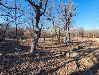 Beautiful corner lot build site with lake views and mature oak on Nocona Hills Golf Course in Texas - for sale on GolfHomes.com, golf home, golf lot