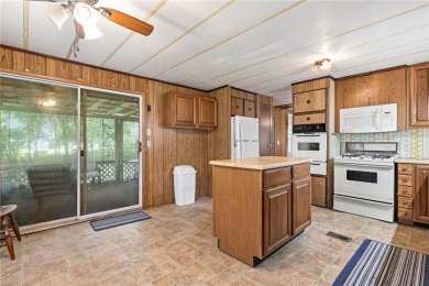 Nice weekend home on 3 LOTS (649, 650, and 651) on popular Buck on Linn Valley Lakes - Deer Trace Golf Course in Kansas - for sale on GolfHomes.com, golf home, golf lot