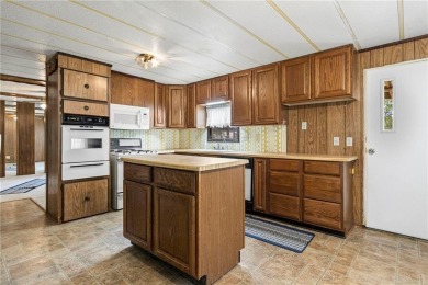 Nice weekend home on 3 LOTS (649, 650, and 651) on popular Buck on Linn Valley Lakes - Deer Trace Golf Course in Kansas - for sale on GolfHomes.com, golf home, golf lot
