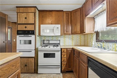 Nice weekend home on 3 LOTS (649, 650, and 651) on popular Buck on Linn Valley Lakes - Deer Trace Golf Course in Kansas - for sale on GolfHomes.com, golf home, golf lot