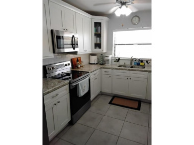 Nicely upgraded, top floor, fully tiled condo with screened on Sunrise Lakes Phase IV Golf Course in Florida - for sale on GolfHomes.com, golf home, golf lot