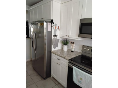 Nicely upgraded, top floor, fully tiled condo with screened on Sunrise Lakes Phase IV Golf Course in Florida - for sale on GolfHomes.com, golf home, golf lot