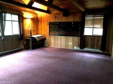 Tanglwood Lakes sprawling home situated on a level wooded lot on Paupack Hills Golf and Country Club in Pennsylvania - for sale on GolfHomes.com, golf home, golf lot