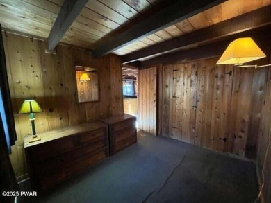 Tanglwood Lakes sprawling home situated on a level wooded lot on Paupack Hills Golf and Country Club in Pennsylvania - for sale on GolfHomes.com, golf home, golf lot