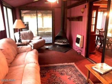Tanglwood Lakes sprawling home situated on a level wooded lot on Paupack Hills Golf and Country Club in Pennsylvania - for sale on GolfHomes.com, golf home, golf lot