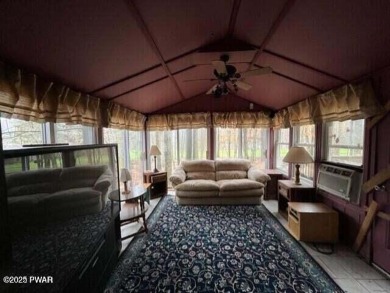 Tanglwood Lakes sprawling home situated on a level wooded lot on Paupack Hills Golf and Country Club in Pennsylvania - for sale on GolfHomes.com, golf home, golf lot