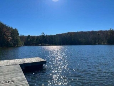 Tanglwood Lakes sprawling home situated on a level wooded lot on Paupack Hills Golf and Country Club in Pennsylvania - for sale on GolfHomes.com, golf home, golf lot