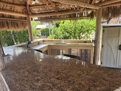 Well appointed back in lot with Tiki on the natural pond.  Soak on St. Lucie Trail Golf Club in Florida - for sale on GolfHomes.com, golf home, golf lot