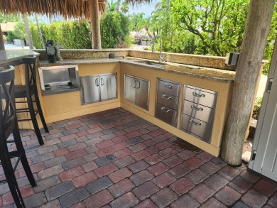 Well appointed back in lot with Tiki on the natural pond.  Soak on St. Lucie Trail Golf Club in Florida - for sale on GolfHomes.com, golf home, golf lot