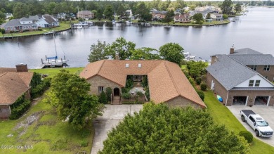 This Mediterranean-style brick home offers panoramic views of on Harbour Point Golf Club in North Carolina - for sale on GolfHomes.com, golf home, golf lot