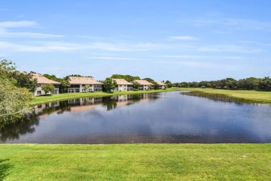Stunning lake views are the showstopping feature of this on Boca Delray Golf and Country Club in Florida - for sale on GolfHomes.com, golf home, golf lot