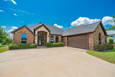 BEAUTIFUL STONE AND BRICK HOME on the par 3, 14th hole of the on Pecan Plantation Country Club in Texas - for sale on GolfHomes.com, golf home, golf lot