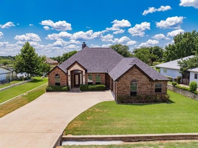 BEAUTIFUL STONE AND BRICK HOME on the par 3, 14th hole of the on Pecan Plantation Country Club in Texas - for sale on GolfHomes.com, golf home, golf lot