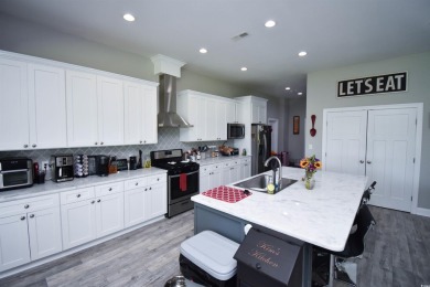 This beautifully landscaped property is situated directly on the on Wild Wing Plantation in South Carolina - for sale on GolfHomes.com, golf home, golf lot
