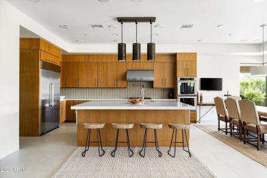 As you enter, you're greeted by soaring ceilings and walls of on Desert Mountain Golf Club - Renegade Course in Arizona - for sale on GolfHomes.com, golf home, golf lot