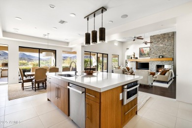 As you enter, you're greeted by soaring ceilings and walls of on Desert Mountain Golf Club - Renegade Course in Arizona - for sale on GolfHomes.com, golf home, golf lot