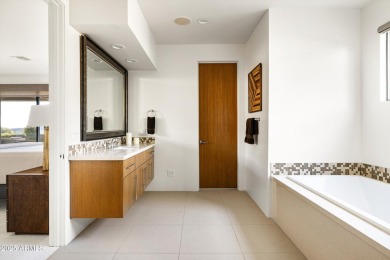 As you enter, you're greeted by soaring ceilings and walls of on Desert Mountain Golf Club - Renegade Course in Arizona - for sale on GolfHomes.com, golf home, golf lot