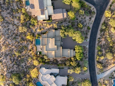 As you enter, you're greeted by soaring ceilings and walls of on Desert Mountain Golf Club - Renegade Course in Arizona - for sale on GolfHomes.com, golf home, golf lot