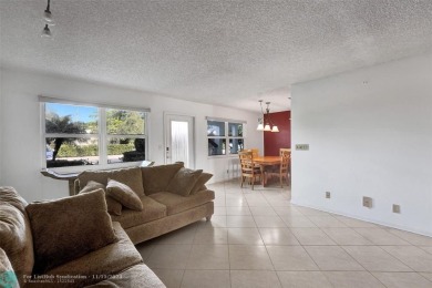 GROUND FLOOR unit with LAKE VIEW located in the desirable on Hillsboro Pines Golf in Florida - for sale on GolfHomes.com, golf home, golf lot