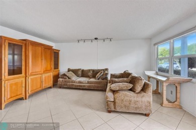 GROUND FLOOR unit with LAKE VIEW located in the desirable on Hillsboro Pines Golf in Florida - for sale on GolfHomes.com, golf home, golf lot