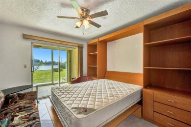 GROUND FLOOR unit with LAKE VIEW located in the desirable on Hillsboro Pines Golf in Florida - for sale on GolfHomes.com, golf home, golf lot