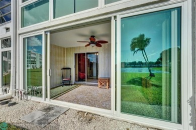 GROUND FLOOR unit with LAKE VIEW located in the desirable on Hillsboro Pines Golf in Florida - for sale on GolfHomes.com, golf home, golf lot