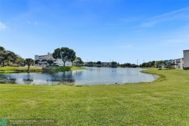 GROUND FLOOR unit with LAKE VIEW located in the desirable on Hillsboro Pines Golf in Florida - for sale on GolfHomes.com, golf home, golf lot