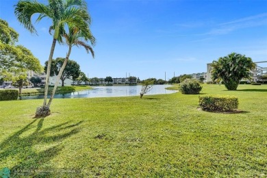 GROUND FLOOR unit with LAKE VIEW located in the desirable on Hillsboro Pines Golf in Florida - for sale on GolfHomes.com, golf home, golf lot