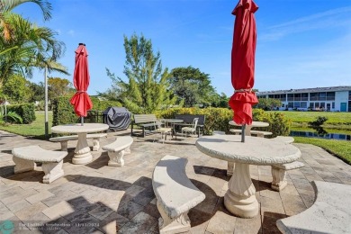 GROUND FLOOR unit with LAKE VIEW located in the desirable on Hillsboro Pines Golf in Florida - for sale on GolfHomes.com, golf home, golf lot