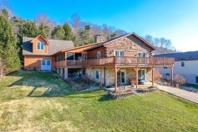 Discover the allure of this cozy lakefront log home at Lake on Lake Mohawk Golf Club in Ohio - for sale on GolfHomes.com, golf home, golf lot